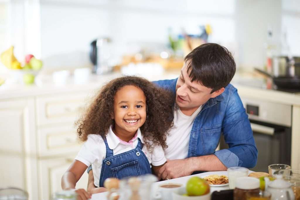 father and daughter having breakfast