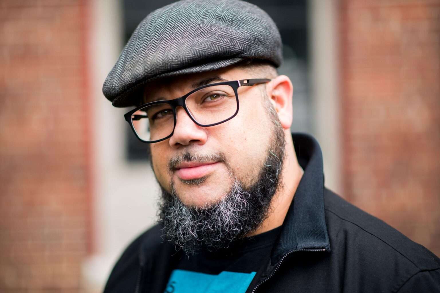 man with glasses, beard, and a hat