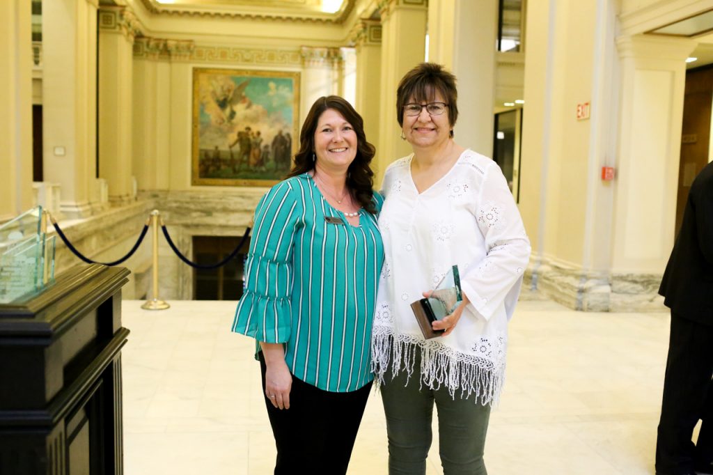 donna keller with DCCCA Tallgrass employee Lori Bichelmeyer posing for a photo