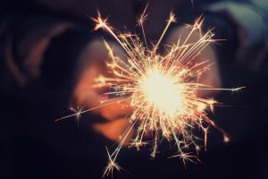 child hands holding sparkler 4th of July